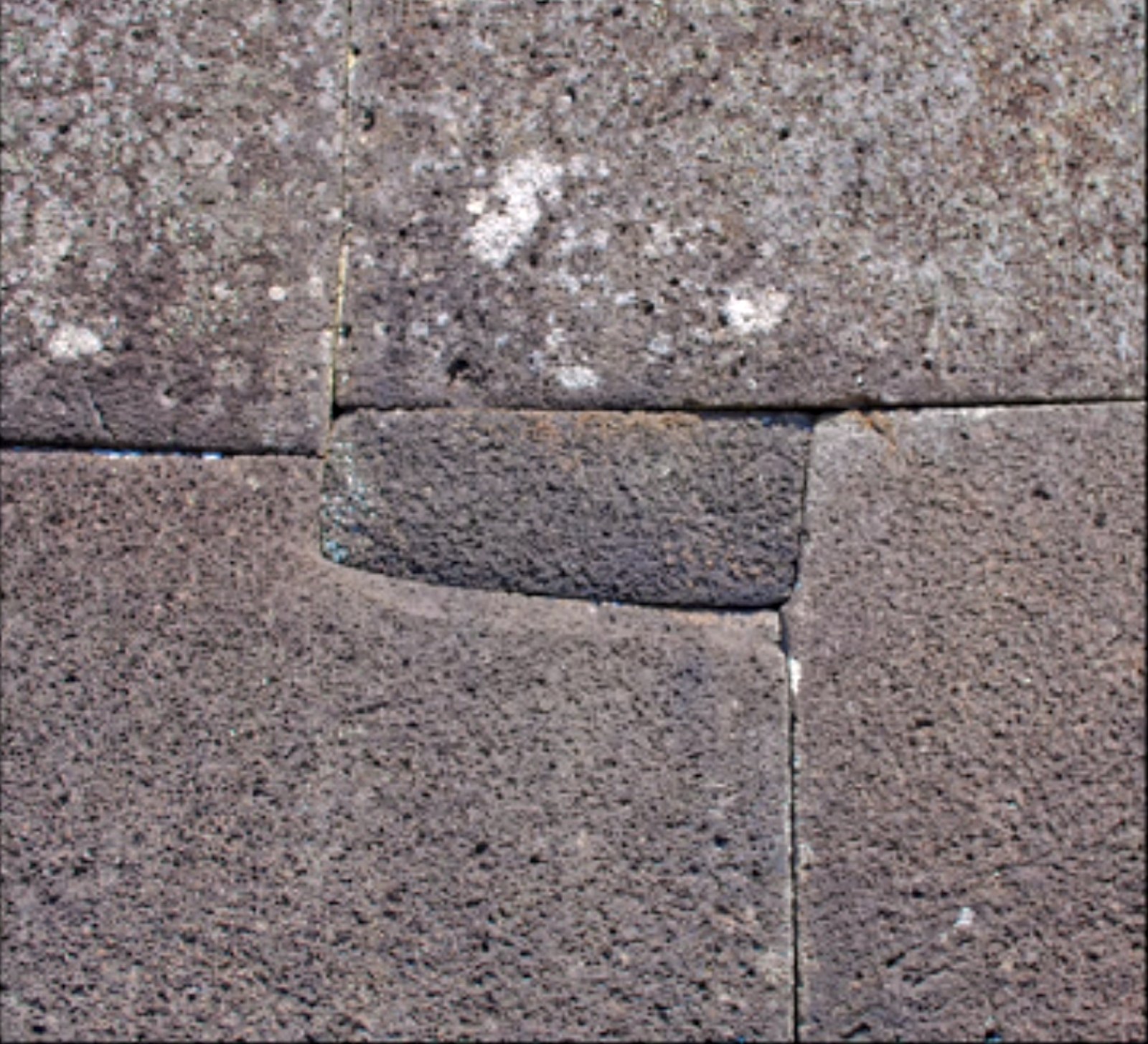 Ahu Vinapu mini megalith on Easter Island: a rectangular inset stone fitted into an L-step cut in basalt.